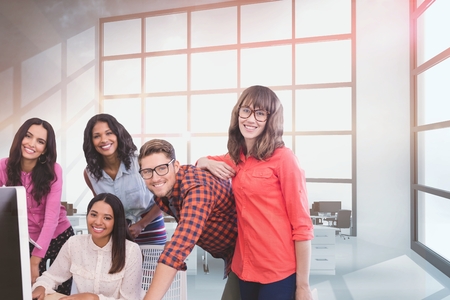 Digital composite of Happy business people at a desk using a computerの写真素材