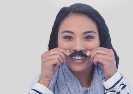 Digital composite of Portrait of woman wearing mustache with grey backgroundの写真素材