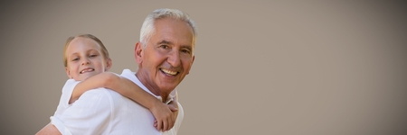 Digital composite of Girl and grandfather piggyback against brown background
