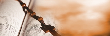 Digital composite of Rosary on bible and blurry orange transitionの写真素材