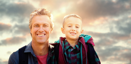 A father and his son posing  against low angle view of skyの写真素材