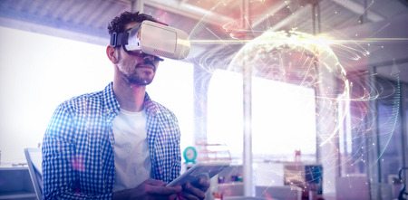 Global technology background in green against executive using virtual reality headset and digital...