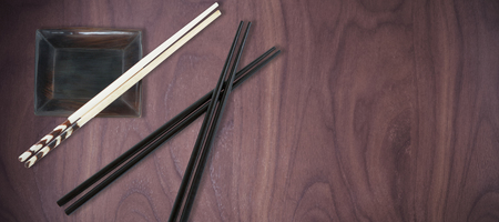 Close up of chopstick with bowl against wood backgroundの写真素材