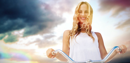 Digital composite of women going on a bike ride against scenic view of sky