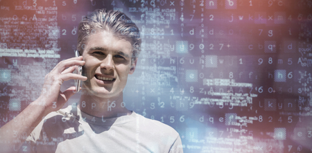 Dark room against portrait of a young man using mobile phoneの写真素材