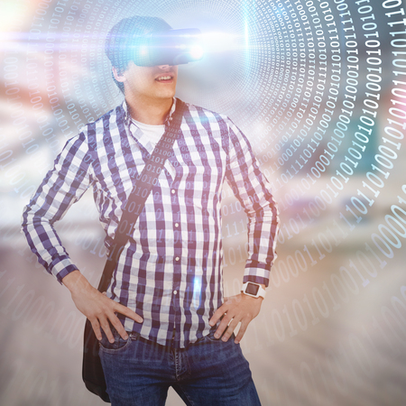 Young man with hand on hop wearing virtual reality simulator glasses against spiral of shiny binary...