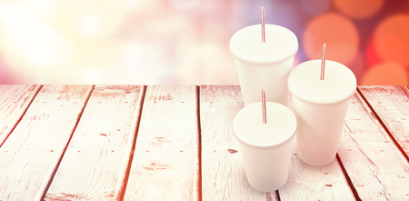 White cups over white background against glowing backgroundの写真素材