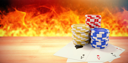 Tilt image of playing cards with casino tokens against composite image of brown parquetの写真素材