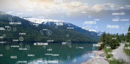 Sphere of icons and words against lake and mountains against skyの写真素材