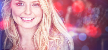 Portrait of beautiful young woman with blond hair at cafeの写真素材