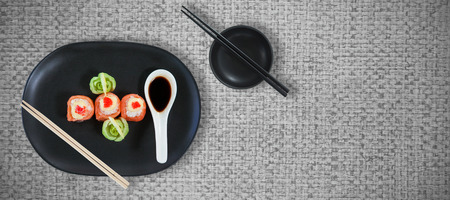 High angle view of fresh japanese food with sauce against close up of sushi matの写真素材