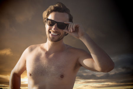 handsome men with sunglasses  against cloudy sky landscapeの写真素材