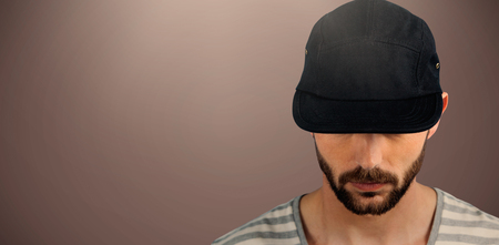 Portrait of man wearing black hat  against brown background