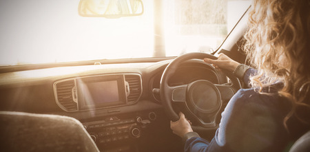 Side view of woman test driving at showroomの写真素材