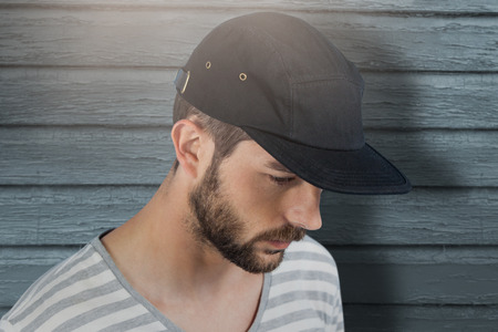 Handsome man wearing hat  against full frame shot of turquoise wallの写真素材