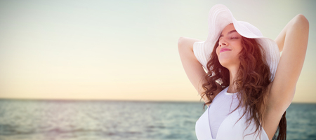 Portrait of women wearing a hat in summer  against sea against clear skyの写真素材