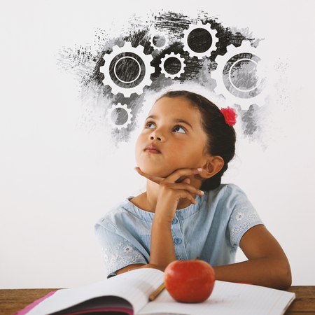 Digital composite image of gears on black spray paint against thoughtful young girl sittingの写真素材
