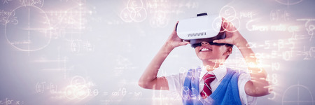 Mathematical equations solved on blackboard against schoolboy using virtual reality headsetの写真素材