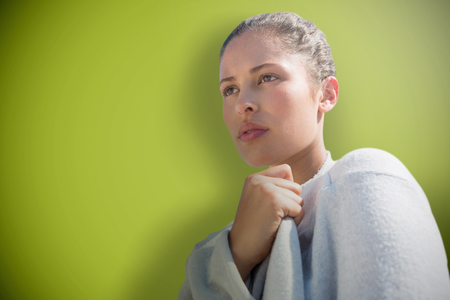 Closeup beauty portrait of a young beautiful woman against green backgroundの写真素材