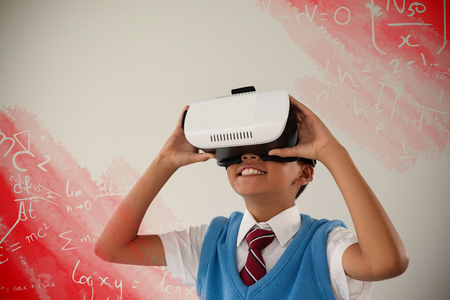 Digital image of equations against schoolboy using virtual reality headsetの写真素材