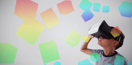 Three dimension image of square with formulas against schoolboy using virtual reality headsetの写真素材