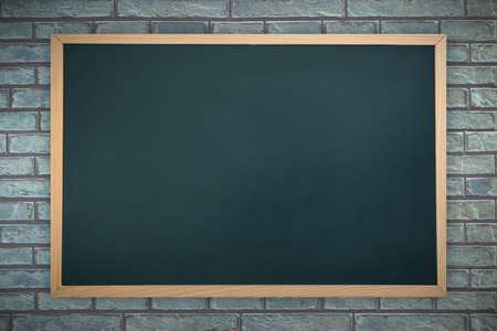 Chalkboard against a stone wallの写真素材