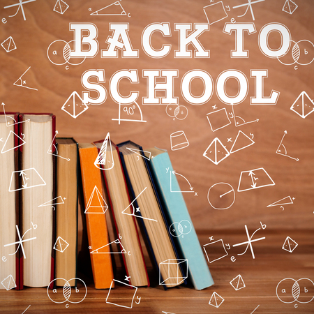 Back to school message against various book on wooden tableの写真素材