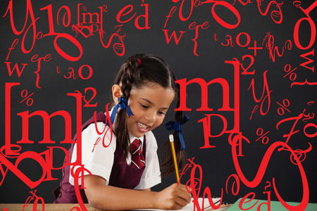 letter and number jumble against schoolgirl doing her homework against chalkboardの写真素材