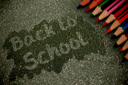 Back to school text on pink splash against multi colored pencils arrangedの写真素材
