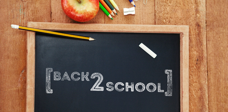 Back to school text over white background against overhead view of chalkboard with pencils and appleの写真素材