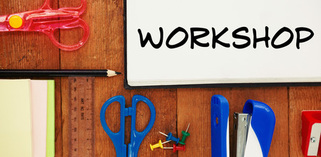 Workshop text on white background against overhead view of school suppliesの写真素材