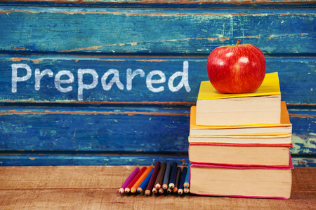 Prepared text on white background against apple with stacked books and pencils on tableの写真素材