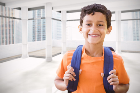 Portrait of smiling boy  against modern room overlooking cityの写真素材