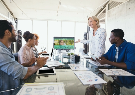 Digital composite of People looking at a computer with e-learning information in the screen