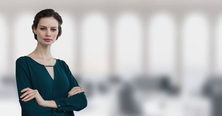 Digital composite of Business woman standing against office backgroundの写真素材