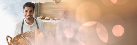 Digital composite of Happy small business owner man holding breadの写真素材