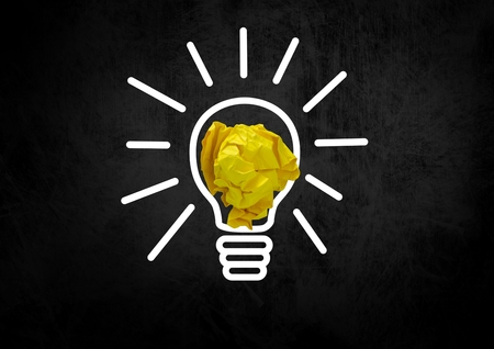 Digital composite of light bulb with crumpled paper ballの写真素材