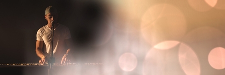 Digital composite of Man singing and playing piano with yellow lightsの写真素材