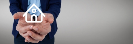 Digital composite of Hands holding a house icon as house insurance conceptの写真素材