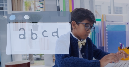 Digital composite of Education icon against office kid boy using a computer backgroundの写真素材