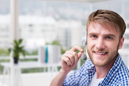 Digital composite of Customer care representative man against office backgroundの写真素材