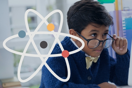 Digital composite of Science icon against office kid boy looking at a computer backgroundの写真素材