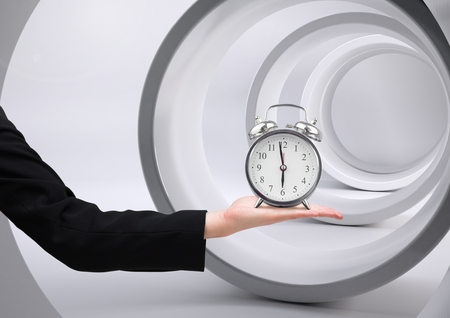 Digital composite of Arm holding clock in front of tunnel circles