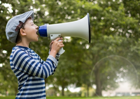Digital composite of Boy with megaphone in front of treesの写真素材