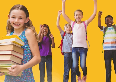 Digital composite of Kids jumping for joy in room with books and yellow backgroundの写真素材