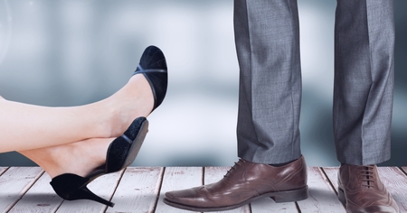 Digital composite of Businesswoman and businessman's feet and shoesの写真素材