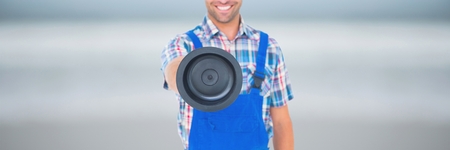 Digital composite of Happy plumber man holding a plungerの写真素材