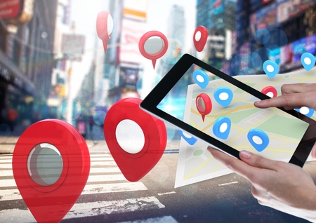 Digital composite of Holding tablet and City with  marker location pointers and map