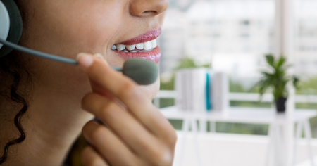 Digital composite of Customer care representative woman against office backgroundの写真素材