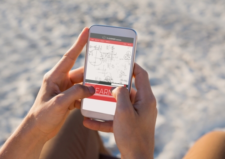 Digital composite of Person using a phone with E-Learning information in the screenの写真素材